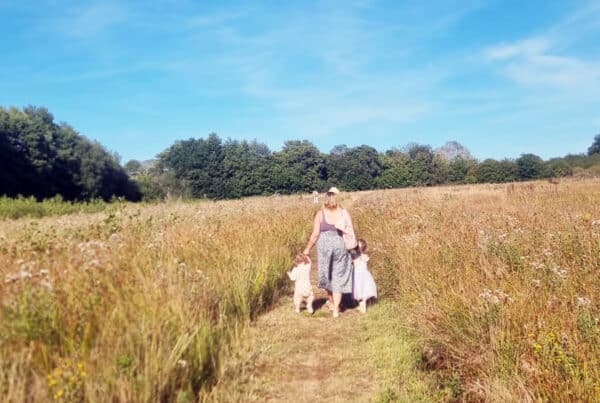 Lorna Syson walking with her children at Castle wild campsite Norfolk