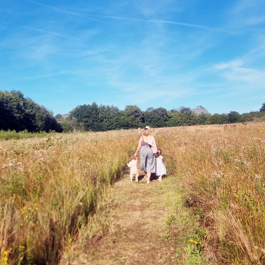 Lorna Syson walking with her children at Castle wild campsite Norfolk