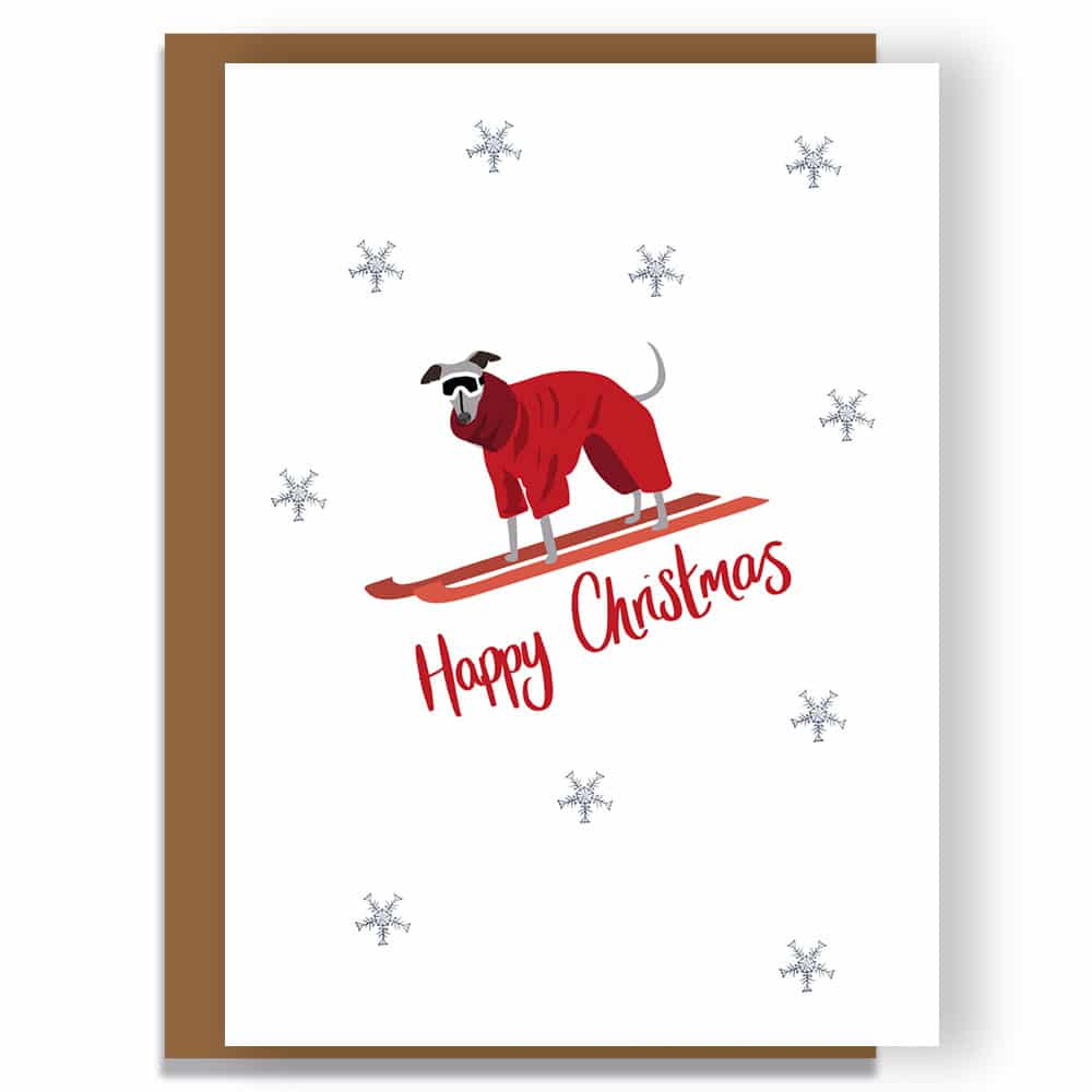luxury christmas card, designer christmas card. Whipped on ski's wearing a winter outfit.