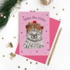 Fabulous, Feline & Festive Christmas card featuring a grey tabby wearing a tinsel and bauble crown on a pink background