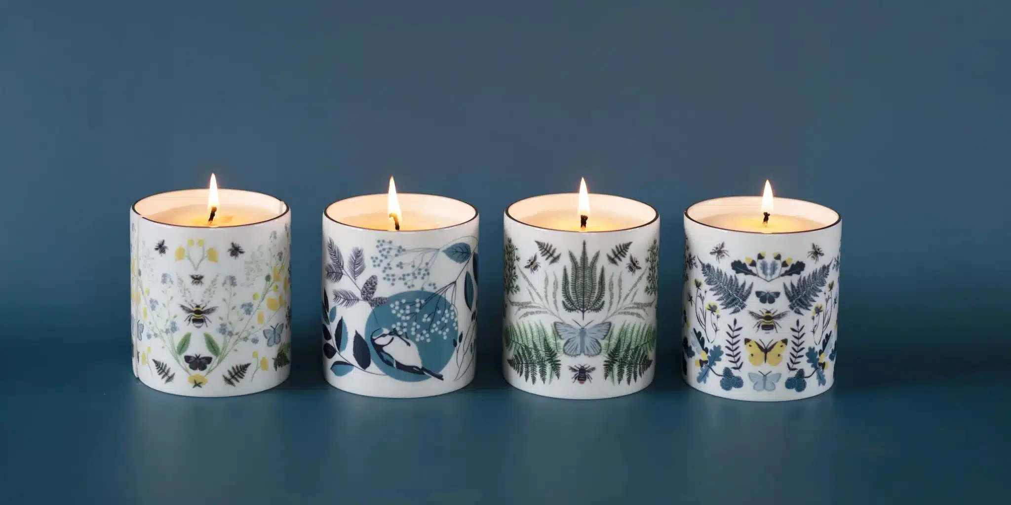 Ceramic candle pot decorated with an illustrated bird and floral pattern, matching the same design found on Lorna Syson homewares